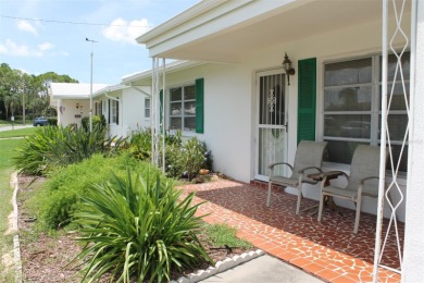 This single-family home, on a corner lot, located in Mainlands on Mainlands Golf Club in Florida - for sale on GolfHomes.com, golf home, golf lot