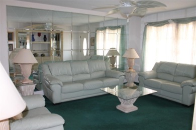 This single-family home, on a corner lot, located in Mainlands on Mainlands Golf Club in Florida - for sale on GolfHomes.com, golf home, golf lot