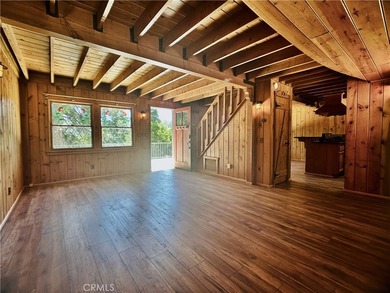 Nestled beneath towering pine trees, this charming 3-bedroom on Lake Arrowhead Country Club in California - for sale on GolfHomes.com, golf home, golf lot