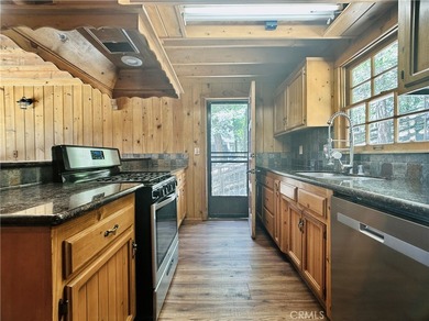 Nestled beneath towering pine trees, this charming 3-bedroom on Lake Arrowhead Country Club in California - for sale on GolfHomes.com, golf home, golf lot