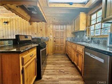 Nestled beneath towering pine trees, this charming 3-bedroom on Lake Arrowhead Country Club in California - for sale on GolfHomes.com, golf home, golf lot