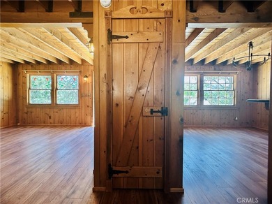 Nestled beneath towering pine trees, this charming 3-bedroom on Lake Arrowhead Country Club in California - for sale on GolfHomes.com, golf home, golf lot