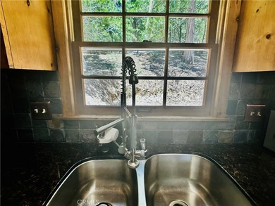 Nestled beneath towering pine trees, this charming 3-bedroom on Lake Arrowhead Country Club in California - for sale on GolfHomes.com, golf home, golf lot