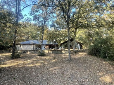 Secluded 3 bedroom 2 Bath home surrounded on all 4 sides by on Holly Lake Ranch Golf Club in Texas - for sale on GolfHomes.com, golf home, golf lot