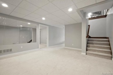 Enjoy maintenance-free golf course living on the first green of on Pine Knob Golf Club - Hawk in Michigan - for sale on GolfHomes.com, golf home, golf lot