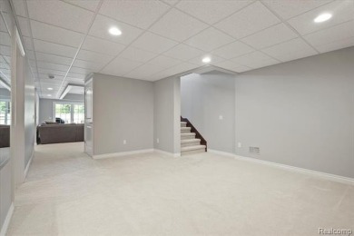 Enjoy maintenance-free golf course living on the first green of on Pine Knob Golf Club - Hawk in Michigan - for sale on GolfHomes.com, golf home, golf lot