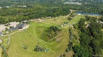 Enjoy maintenance-free golf course living on the first green of on Pine Knob Golf Club - Hawk in Michigan - for sale on GolfHomes.com, golf home, golf lot