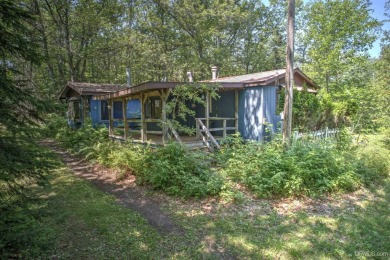 Nestled in the tranquil woods of Calumet on a dead end road on Calumet Golf Course in Michigan - for sale on GolfHomes.com, golf home, golf lot