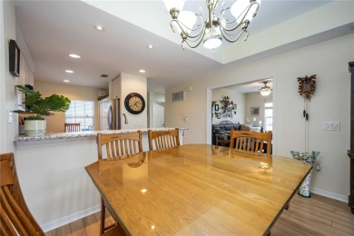 Enjoy waterfront living in this turnkey bright end-unit villa on Sabal Trace Golf and Country Club in Florida - for sale on GolfHomes.com, golf home, golf lot
