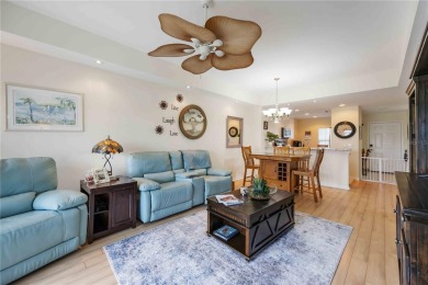 Enjoy waterfront living in this turnkey bright end-unit villa on Sabal Trace Golf and Country Club in Florida - for sale on GolfHomes.com, golf home, golf lot