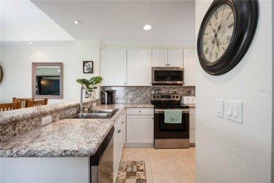 Enjoy waterfront living in this turnkey bright end-unit villa on Sabal Trace Golf and Country Club in Florida - for sale on GolfHomes.com, golf home, golf lot