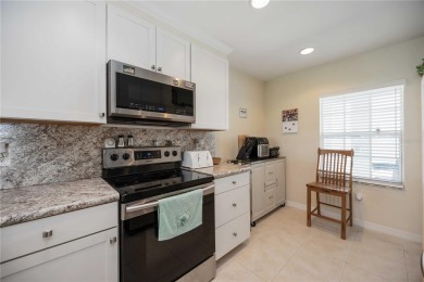 Enjoy waterfront living in this turnkey bright end-unit villa on Sabal Trace Golf and Country Club in Florida - for sale on GolfHomes.com, golf home, golf lot