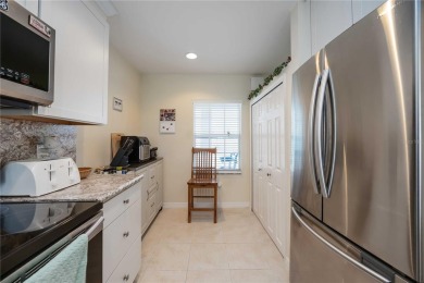 Enjoy waterfront living in this turnkey bright end-unit villa on Sabal Trace Golf and Country Club in Florida - for sale on GolfHomes.com, golf home, golf lot