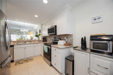 Enjoy waterfront living in this turnkey bright end-unit villa on Sabal Trace Golf and Country Club in Florida - for sale on GolfHomes.com, golf home, golf lot