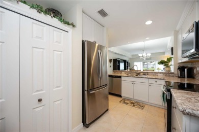 Enjoy waterfront living in this turnkey bright end-unit villa on Sabal Trace Golf and Country Club in Florida - for sale on GolfHomes.com, golf home, golf lot