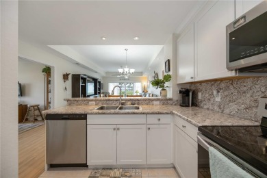 Enjoy waterfront living in this turnkey bright end-unit villa on Sabal Trace Golf and Country Club in Florida - for sale on GolfHomes.com, golf home, golf lot