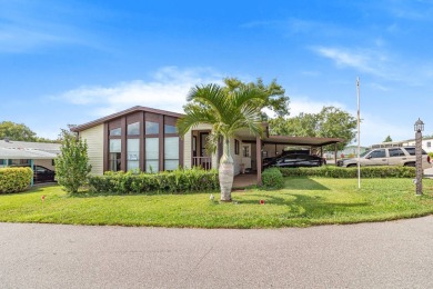 Discover a charming 2-bedroom, 2-bathroom home in the Swiss on Lake Henry Golf Club in Florida - for sale on GolfHomes.com, golf home, golf lot