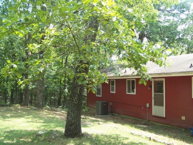 This charming 2 bedroom 1 1/2 bath is nestled among large shade on The Course At Turkey Mountain in Arkansas - for sale on GolfHomes.com, golf home, golf lot