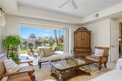 This first floor coach home has a spectacular lake and island on Lely Resort Golf and Country Club in Florida - for sale on GolfHomes.com, golf home, golf lot