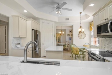 This first floor coach home has a spectacular lake and island on Lely Resort Golf and Country Club in Florida - for sale on GolfHomes.com, golf home, golf lot