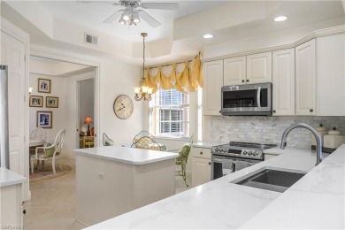 This first floor coach home has a spectacular lake and island on Lely Resort Golf and Country Club in Florida - for sale on GolfHomes.com, golf home, golf lot