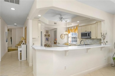 This first floor coach home has a spectacular lake and island on Lely Resort Golf and Country Club in Florida - for sale on GolfHomes.com, golf home, golf lot