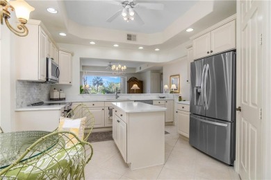 This first floor coach home has a spectacular lake and island on Lely Resort Golf and Country Club in Florida - for sale on GolfHomes.com, golf home, golf lot