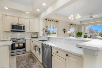 This first floor coach home has a spectacular lake and island on Lely Resort Golf and Country Club in Florida - for sale on GolfHomes.com, golf home, golf lot