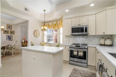 This first floor coach home has a spectacular lake and island on Lely Resort Golf and Country Club in Florida - for sale on GolfHomes.com, golf home, golf lot