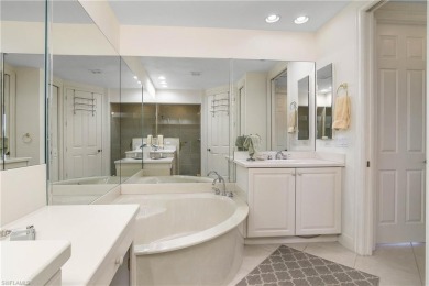 This first floor coach home has a spectacular lake and island on Lely Resort Golf and Country Club in Florida - for sale on GolfHomes.com, golf home, golf lot