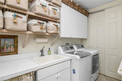 This first floor coach home has a spectacular lake and island on Lely Resort Golf and Country Club in Florida - for sale on GolfHomes.com, golf home, golf lot