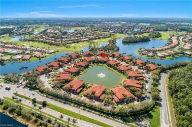 This first floor coach home has a spectacular lake and island on Lely Resort Golf and Country Club in Florida - for sale on GolfHomes.com, golf home, golf lot