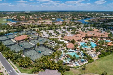 This first floor coach home has a spectacular lake and island on Lely Resort Golf and Country Club in Florida - for sale on GolfHomes.com, golf home, golf lot