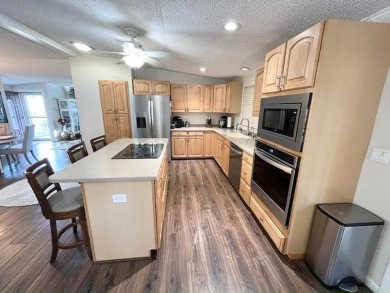 Absolutely stunning 2-bd, 2-ba home with modern updates & a on Del Tura Golf and Country Club in Florida - for sale on GolfHomes.com, golf home, golf lot