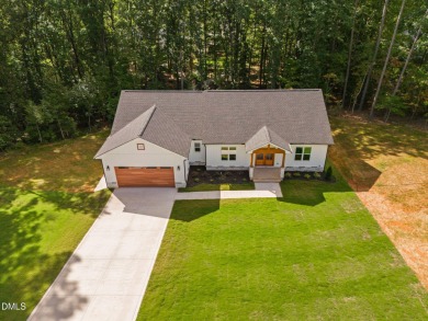 Enjoy one-level living in this beautifully crafted custom ranch on River Golf and Country Club at Lake Royale in North Carolina - for sale on GolfHomes.com, golf home, golf lot