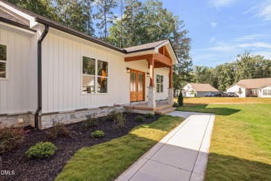 Enjoy one-level living in this beautifully crafted custom ranch on River Golf and Country Club at Lake Royale in North Carolina - for sale on GolfHomes.com, golf home, golf lot