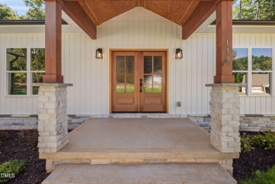 Enjoy one-level living in this beautifully crafted custom ranch on River Golf and Country Club at Lake Royale in North Carolina - for sale on GolfHomes.com, golf home, golf lot