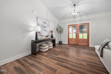 Enjoy one-level living in this beautifully crafted custom ranch on River Golf and Country Club at Lake Royale in North Carolina - for sale on GolfHomes.com, golf home, golf lot