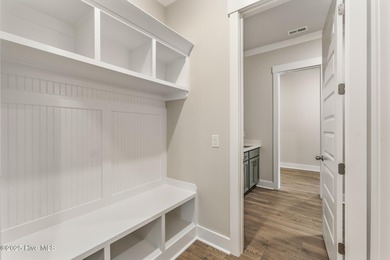 Welcome to your ideal coastal retreat! This beautiful 1.5 story on Crow Creek Golf Club in North Carolina - for sale on GolfHomes.com, golf home, golf lot