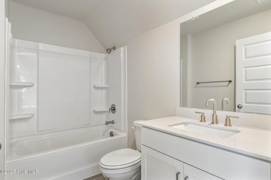 Welcome to your ideal coastal retreat! This beautiful 1.5 story on Crow Creek Golf Club in North Carolina - for sale on GolfHomes.com, golf home, golf lot