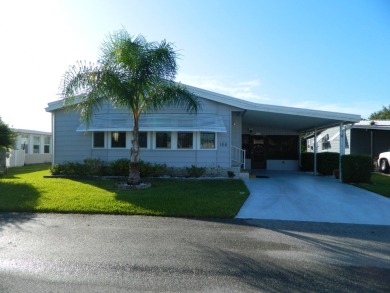 1,801 sq. ft. 2 bed/2 bath 1986 Redman 26x52 features a lanai on on Grasslands Golf and Country Club in Florida - for sale on GolfHomes.com, golf home, golf lot