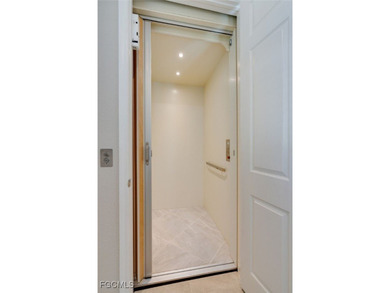 Arrive by PRIVATE ELEVATOR and step into a home that immediately on Pelican Preserve Golf Club in Florida - for sale on GolfHomes.com, golf home, golf lot