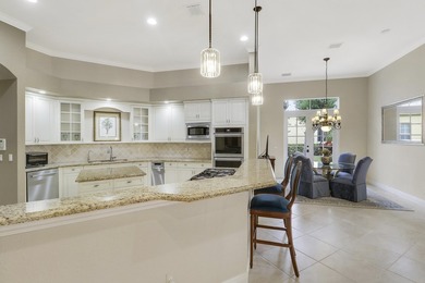 CUSTOM BUILT POOL HOME WITH GOLF & WATER VIEWS in the on The Legacy Golf and Tennis Club in Florida - for sale on GolfHomes.com, golf home, golf lot