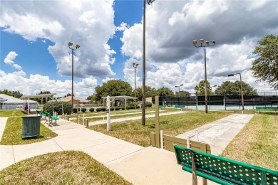 Nestled in an active 55+ community, this 3-bedroom, 2-bath home on Summerglen Country Club in Florida - for sale on GolfHomes.com, golf home, golf lot