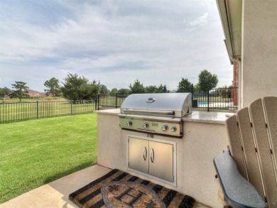 Nestled within the prestigious Oak Tree Golf and Country Club on Oak Tree National Golf and Country Club in Oklahoma - for sale on GolfHomes.com, golf home, golf lot