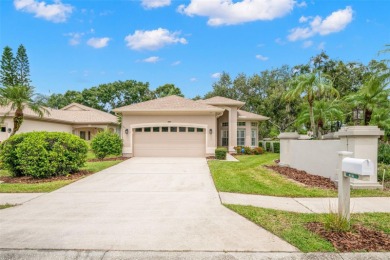 Walk up as you take in the lush landscape and brick paved front on East Lake Woodlands Country Club in Florida - for sale on GolfHomes.com, golf home, golf lot