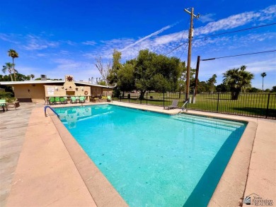 Floor to ceiling windows capture the relaxing golf course views on Yuma Golf and Country Club in Arizona - for sale on GolfHomes.com, golf home, golf lot