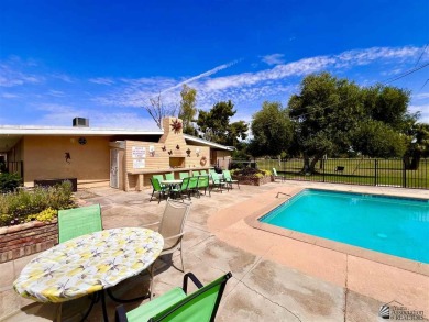 Floor to ceiling windows capture the relaxing golf course views on Yuma Golf and Country Club in Arizona - for sale on GolfHomes.com, golf home, golf lot