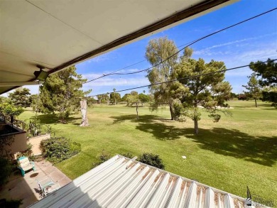 Floor to ceiling windows capture the relaxing golf course views on Yuma Golf and Country Club in Arizona - for sale on GolfHomes.com, golf home, golf lot