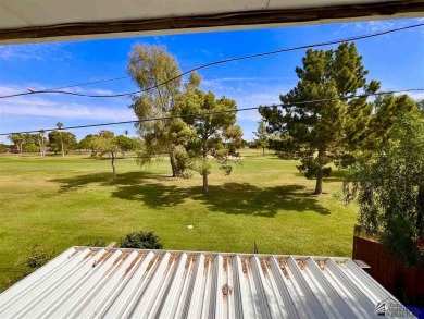 Floor to ceiling windows capture the relaxing golf course views on Yuma Golf and Country Club in Arizona - for sale on GolfHomes.com, golf home, golf lot